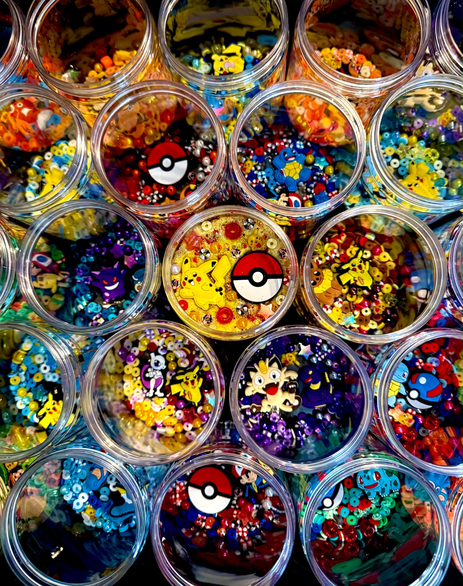 A colourful collection of decorated slime pots with beads and character charms