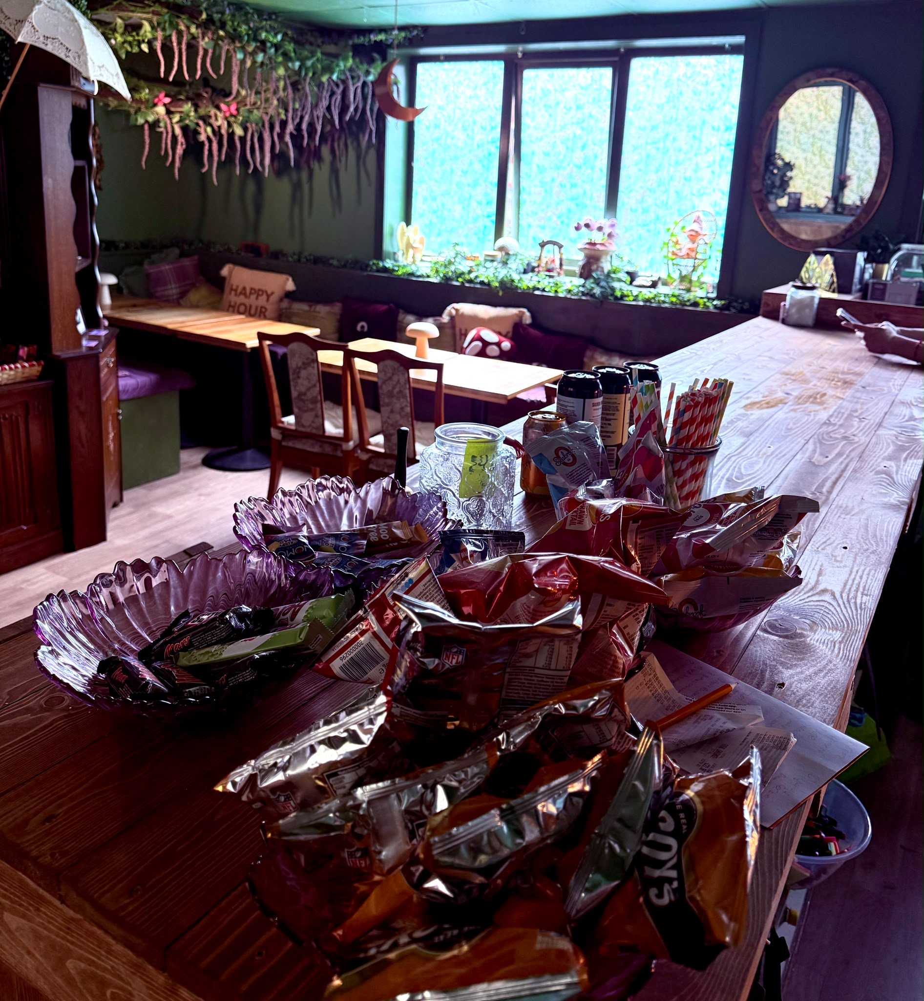 Bowls of snacks and drinks arranged along a wooden counter at the venue