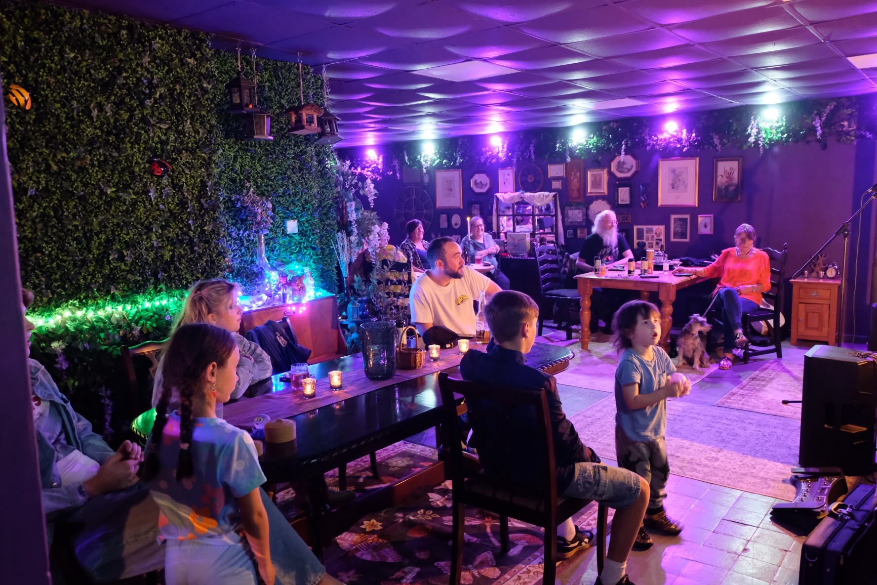 Families enjoying an event in the venue beneath colourful lights